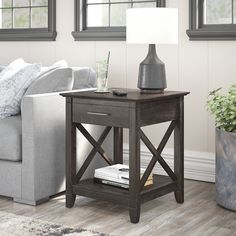 a living room scene with focus on the end table and couch in the foreground