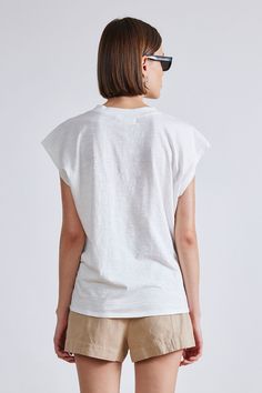 100% Cotton Made in India Crew neckline, cap sleeve Machine wash cold on gentle cycle with like colors, lay flat to air dry Fits true to size. Select your usual size Model is 5'10" and wearing a size small White Cap Sleeve Top For Spring, White Cap Sleeve T-shirt, White Cotton Cap Sleeve Top, Casual White Cap Sleeve Tops, Casual White T-shirt With Cap Sleeves, Summer Cap Sleeve Tops, Everyday Cotton Cap Sleeve Tops, Relaxed Fit Cotton Top With Cap Sleeves, Man Dressing Style