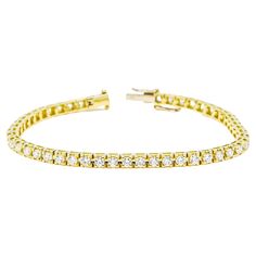 Elevate your style with this exquisite 18K Yellow Gold Four Prong Tennis Bracelet. Crafted with meticulous attention to detail, it features a continuous line of dazzling round-cut natural diamonds, totaling 5.00 carats. Each diamond is expertly hand-set in a secure four-prong setting, allowing for maximum brilliance and light reflection. The warm tones of the 18K yellow gold complement the diamonds beautifully, creating a radiant and luxurious piece that is sure to captivate. This tennis bracele Bracelet Tennis, Continuous Line, Light Reflection, Tennis Bracelet, Elevate Your Style, Elegant Gift, San Valentino, Diamond Shapes, Prong Setting