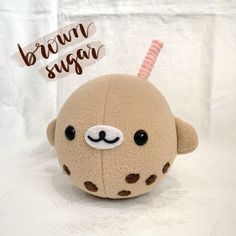 a brown stuffed animal with a pink straw sticking out of it's nose and eyes