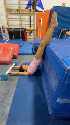 a woman is doing exercises on the trampoline