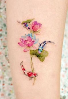 a woman's leg with flowers and koi fish on it