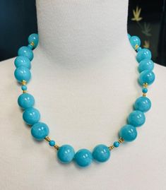 This stunning statement necklace features a beautiful collection of perfectly matched, 18mm round amazonite beads with vibrant, gorgeous color! The large amazonite beads are paired with smaller turquoise beads and decorative 18k yellow gold embellishments that give this strand a rich and luxurious feel. A beautiful clasp adds the perfect finishing touch to this impressive necklace that is sure to turn heads! Necklace measures 21.5 inches in length. Elegant Round Bead Amazonite Jewelry, Elegant Amazonite Round Beads Jewelry, Elegant Round Beaded Amazonite Jewelry, Elegant Amazonite Necklace With Faceted Beads, Turquoise Amazonite Beaded Necklace, Blue Amazonite Jewelry With Polished Beads, Elegant Amazonite Bead Necklaces, Elegant Turquoise Necklace With Large Blue Beads, Elegant Turquoise Beaded Gems And Cabochons