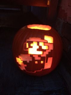 a pumpkin carved to look like an image of a person's face is glowing in the dark