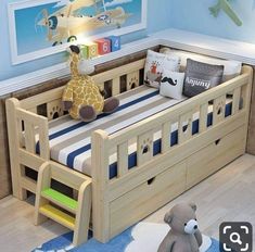 a child's bed with a stuffed animal on the bottom bunk and blue walls