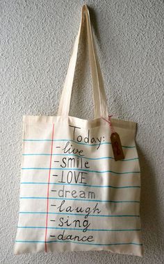 a tote bag hanging on the wall with words written on it that read today, live love dream laugh sing dance