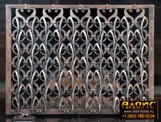 an old metal grate sitting on top of a black table next to a window