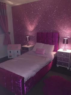 a bedroom with pink glitter walls and purple bedding, two nightstands on either side