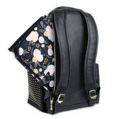 a black backpack with floral print and gold hardwares on the front, open to reveal its contents