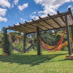 an outdoor area with hammocks and trees