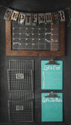 a blackboard with calendars and magnets attached to it