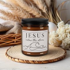 a jar of jesus makes the story candle on a wicker coaster