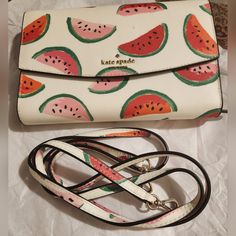 Interesting And Versatile Little Bag/Wallet! This Is A Bag And A Wallet In One. Perfect For That Minimalist! Colorful! Exterior Watermelon Slices On A White Background On Cross Hatched Coated Fabric Silver Tone Hardware Throughout Kate Spade New York And Logo Spade On Flap Slip Exterior Pocket Two Exterior D Rings For Detachable Strap Detachable Strap In The Same Painted Fabric With A 22-Inch Drop Approximately Snap Button Closure On Front Flap Interior Bag Opens To Access One Large Multipurpose Kate Spade Bags With Card Slots For Gift, Multicolor Rectangular Shoulder Bag By Kate Spade, White Kate Spade Bags With Card Slots, Kate Spade Green Bag With Adjustable Strap, Colorful Exterior, Kate Spade Heart Wallet, Kate Spade Strawberry Wallet, Wristlet Wallet Kate Spade New York, Minimalist Colorful