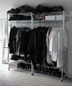 an organized closet with clothes and shoes