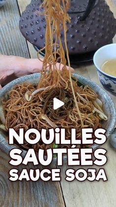 noodles in a bowl being held by someone