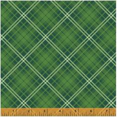 a green plaid fabric with a ruler