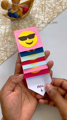 a person holding up a card with the word pull on it and an image of a smiley face