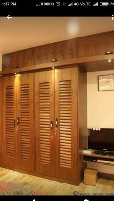 a living room filled with furniture and a flat screen tv on top of a wooden cabinet