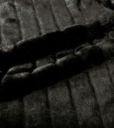 a black and white photo of a cat's paw laying on a couch cushion