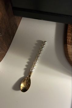 a metal spoon sitting on top of a white counter