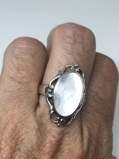 Lovely polished sterling silver has the look of Deco with a huge white Mother Of Pearl set in very detailed vintage filigree Size 7.75 We can size these with an additional $10-$20 fee for the jeweler All rings are shipped in a nice gift box. Check out our over a THOUSAND great reviews Engraving is $4 per letter and is not always perfect depending on the piece. It can take a few days if the jeweler is busy. This is payable to Paypal Judithsltd@gmail.com Classic White Filigree Ring With Intricate Design, White Heirloom Filigree Ring With Intricate Design, Heirloom White Filigree Ring With Intricate Design, White Filigree Fine Jewelry, White Filigree Ring With Intricate Design For Formal Events, White Fine Jewelry With Filigree Details, White Fine Jewelry With Filigree, Fine White Filigree Jewelry, Formal White Filigree Ring With Intricate Design