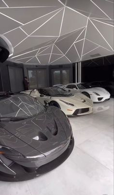 two sports cars are parked in the garage