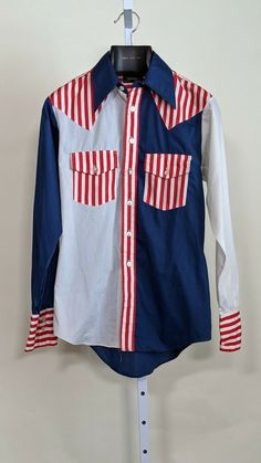 Campus Vintage 60s 70s Americana Flag Shirt Deadstock Medium USA. Shipped with USPS Priority Mail. Appears to be deadstock, couple tiny blemishes from storage. Pit to pit: 21" Length: 28" front 31" back Shoulders: 18" Shoulder to cuff: 26" Spring Americana Long Sleeve Tops, 1970s Cotton Tops With Retro Print, 1970s Retro Print Cotton Top, 1970s Style Cotton Shirt For Spring, 1970s Long Sleeve Summer Tops, Retro Fitted Cotton Shirt, 1970s Fitted Cotton Shirt, 1970s Collared Summer Shirt, 1970s Long Sleeve Cotton Shirt