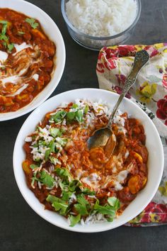 two white bowls filled with food and rice