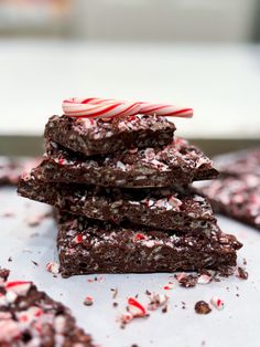 chocolate peppermint brownies stacked on top of each other with candy canes