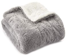 a gray and white blanket on top of a white surface with a light colored border