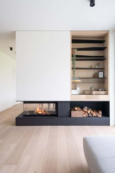 the fireplace is built into the wall in this modern living room with wood flooring