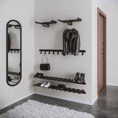 a black and white photo of a shoe rack in a room with shoes hanging on the wall