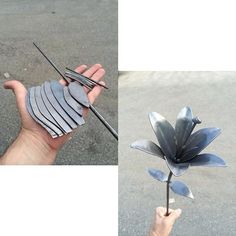 a hand holding a flower made out of metal strips