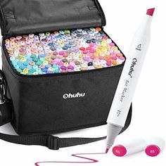 a black bag filled with lots of different colored confetti next to a white marker