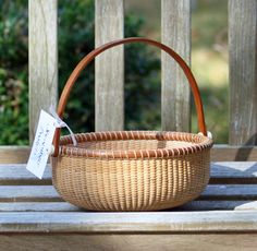 a wicker basket sitting on top of a wooden bench