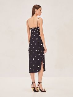 Step into the Malia Cotton Midi Dress for a sleek summer look. Its black backdrop with subtle metallic dots adds a playful touch to the classic midi cut. Simple straps and a figure-skimming fit make it versatile for both day and evening events. Pair it with your favorite heels, and let this dress speak for itself. Polka Dot Midi Dress For Summer Formal, Formal Polka Dot Midi Dress For Summer, Sleeveless Polka Dot Midi Dress For Evening, Black Backdrop, Set Active, Black Backdrops, Cotton Midi Dress, Summer Look, Instagram Shop