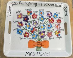 a tray with flowers on it that says thank you for helping us bloom and grow