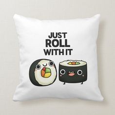 a pillow that says just roll with it and two sushi rolls on the side