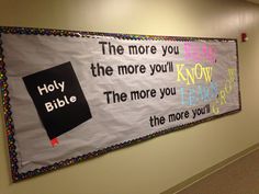 a bulletin board with words on it in an office building hallway that reads the more you read, the more you know