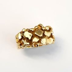 This is a stunning vintage ring! This stunning pinky ring is made of 14k yellow gold. It is a solid, nugget style ring that is beautifully made and is in good condition for its age.  The ring is a size 4 3/4, please contact me for sizing information. The ring is approximately 3/8" wide. It comes in a pouch perfect for safe keeping or gift giving! Mens Pinky Ring, Gold Nugget, Pinky Ring, Vintage Ring, Gift Giving, Rings Statement, Vintage Rings, Statement Rings, Jewelry Rings