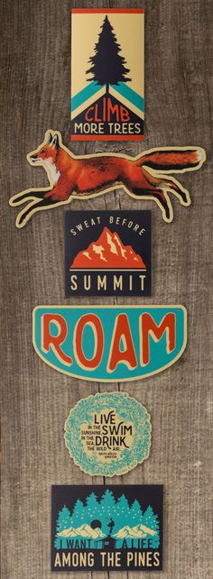 an assortment of stickers on the side of a wooden door that says summer roam