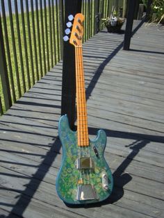 an electric guitar sitting on top of a wooden deck