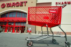 a red shopping cart sitting in front of a target store