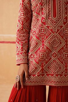 Regal red kurta with bead, cutdana embroidery in geometric pattern. Paired with sharara and dupatta.
Components: 3
Pattern: Embroidery
Type Of Work: Bead, cutdana
Neckline: U neck
Sleeve Type: Full sleeves
Fabric: Kurta: Habutai Silk, Sharara: Georgette, Dupatta: Organza
Color: Red
Other Details: 
Tiered pleated sharara
Sheer embroidered dupatta
Length:
Kurta: 30 inches
Sharara: 42 inches
Occasion: Sangeet - Aza Fashions Sureena Chowdhri, Silk Sharara, Kurta Sharara Set, Red Kurta, Kurta Sharara, Georgette Dupatta, Sharara Set, Pattern Embroidery, U Neck