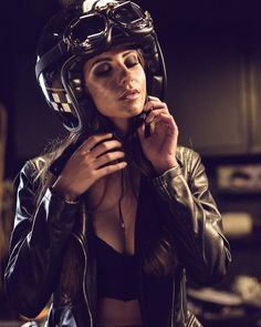 a woman wearing a motorcycle helmet and leather jacket