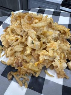 a pile of fried food sitting on top of a checkered table cloth