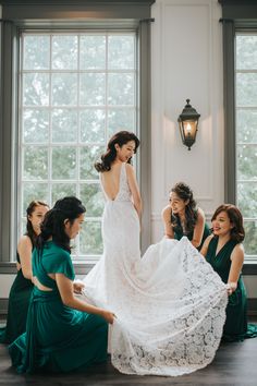 the bride is getting ready to walk down the aisle in her wedding dress with her bridesmaids