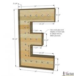 the letter e is made out of wood and has holes in it to hold letters