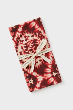 red and white tie - dyed napkins tied together