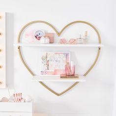 a heart shaped shelf with makeup and cosmetics on it